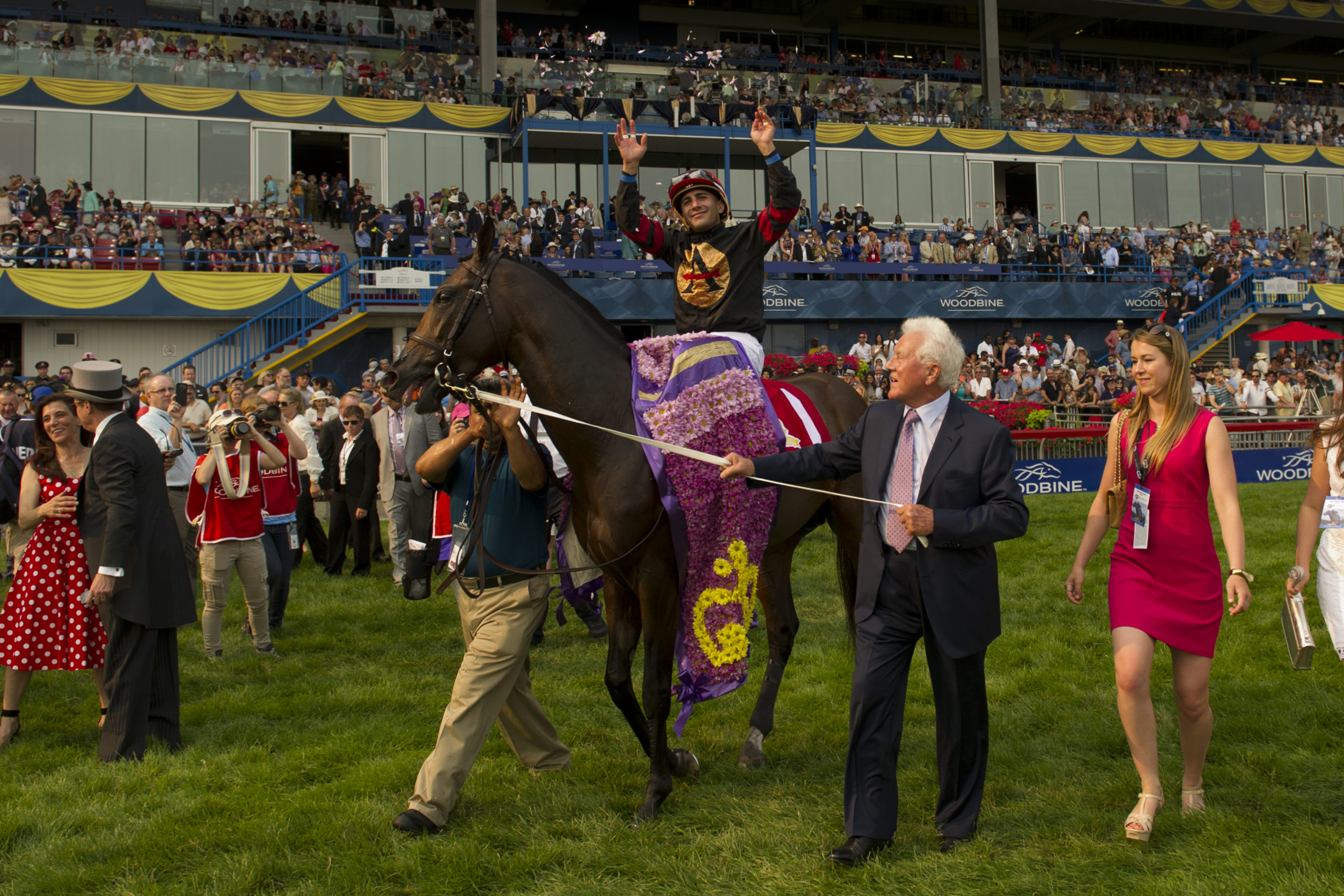 Queen's Plate Stakes winner Shaman Ghost with jockey Rafael Hernandez and owner Frank Stronach.Photo by Michael Burns Photography