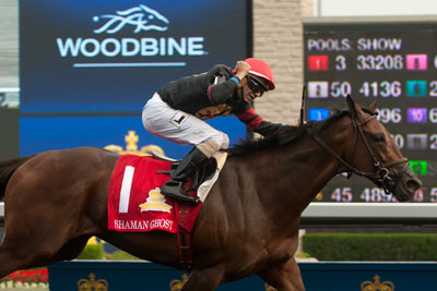 Rafael Hernandez guides Shaman Ghost to victory in the Queen's Plate Stakes. Photo by Michael Burns Photography