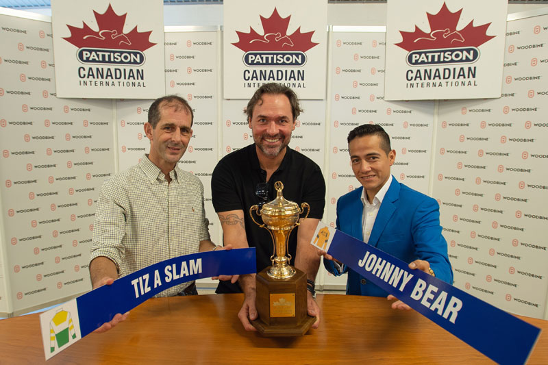 Toronto Maple Leafs alum Darcy Tucker, the guest drawmaster, with jockeys Steven Bahen (left) and Luis Contreras (right) at the post position draw for Saturday's $800,000 Pattison Canadian International (Grade 1), at Woodbine Racetrack. Photo by Michael Burns