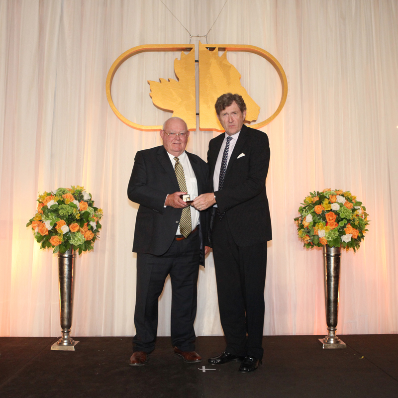 Bill Graham (left) receiving his Canadian Horse Racing Hall of Fame ring at the 2014 induction ceremony from trainer Mike Doyle. Photo courtesy Iron Horse Photo/Canadian Horse Racing Hall of Fame