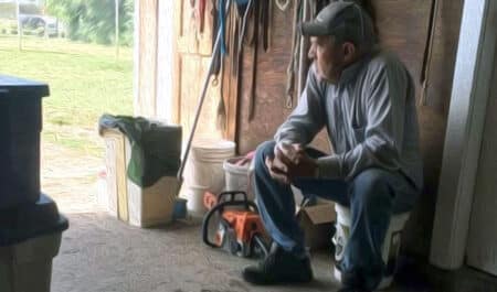 Dale Saunders sitting in a tack room, gazing out the door.
