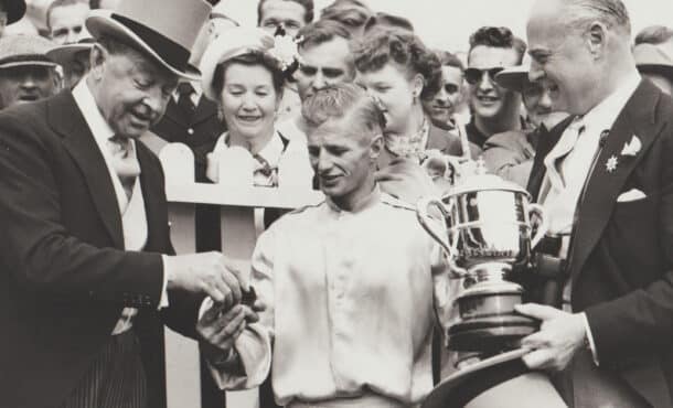 A black-and-white photo of people in the winner's circle in 1951.