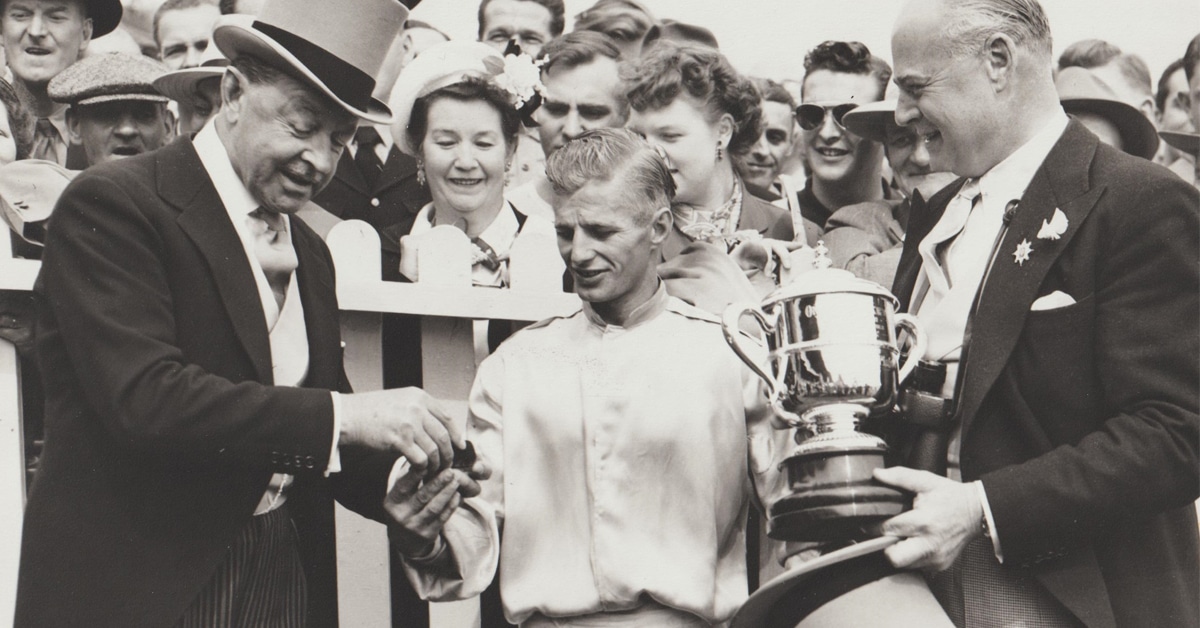A black-and-white photo of people in the winner's circle in 1951.