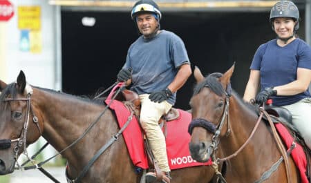 Richard Persad and an assistant riding racetrack ponies.