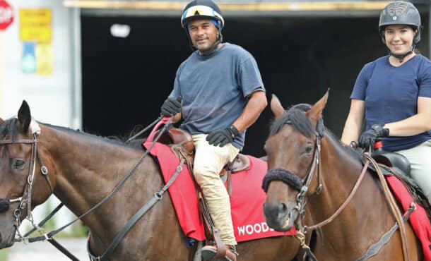 Richard Persad and an assistant riding racetrack ponies.