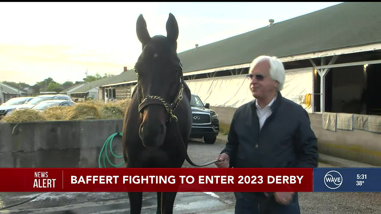 Bob Baffert standing holding a horse.