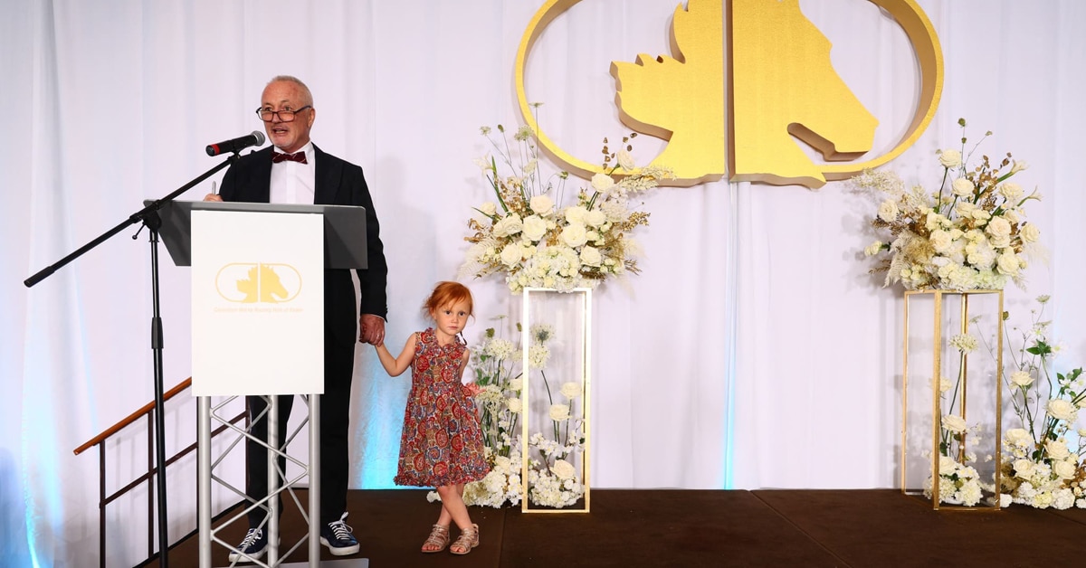 A man standing at a podium with a little girl.