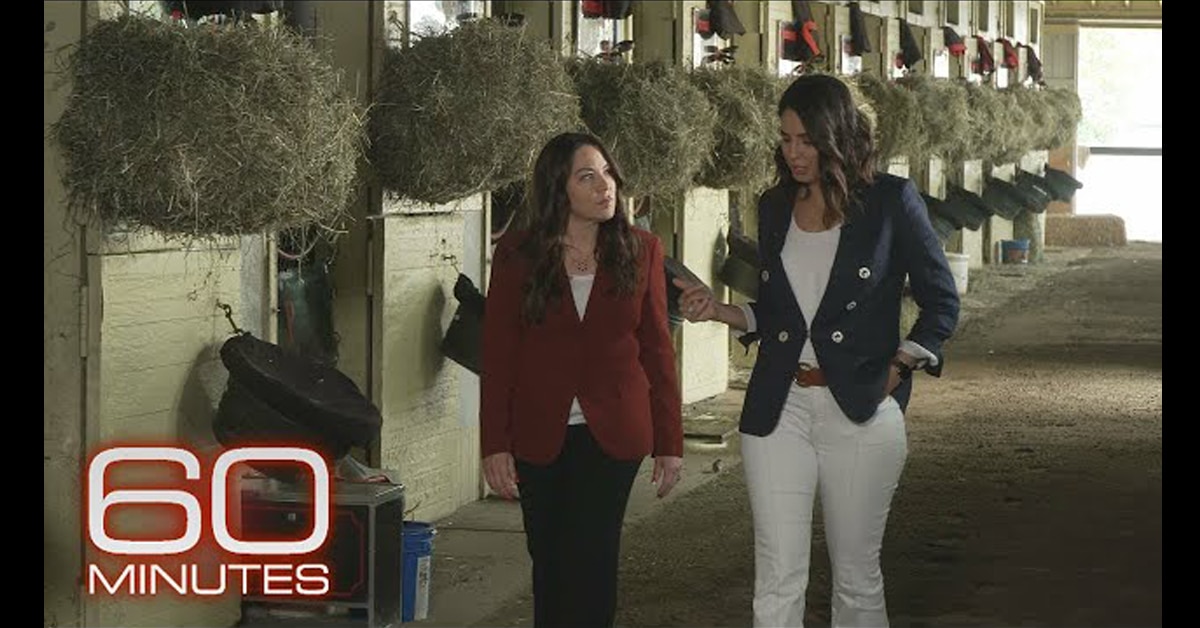 Screenshot of 60 Minutes segment, two women walking in a barn.