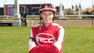 A jockey in red-and-white silks.