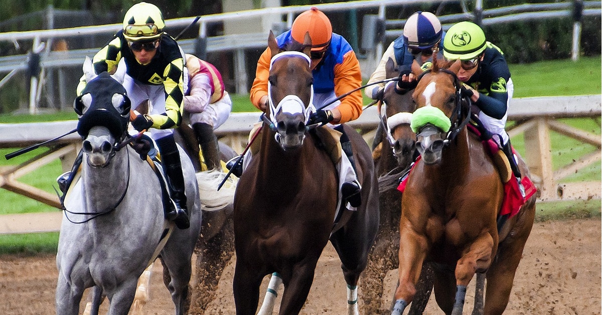 Horses racing on a track.