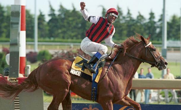 A jockey on a chestnut horse winning a race at Woodbine in 2003.