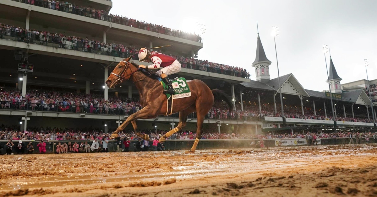 A horse running on a sloppy track at Churchill Downs.